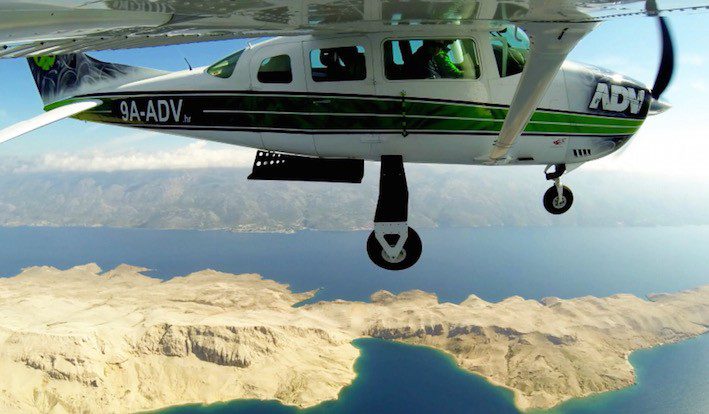 Skydiving airplane Cessna 206 flying over Croatia