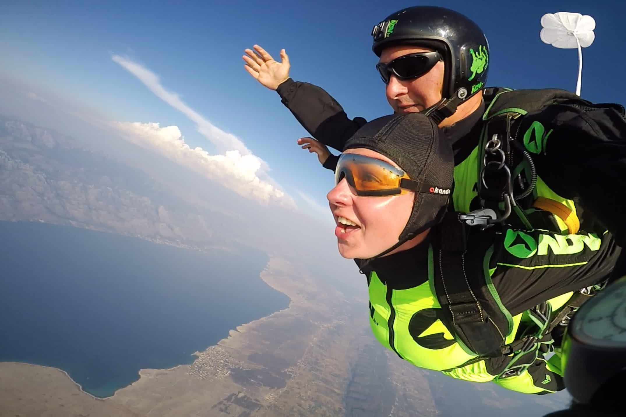 Afraid of heights? 7 reasons to jump from the airplane happy tandem skydiver in free fall
